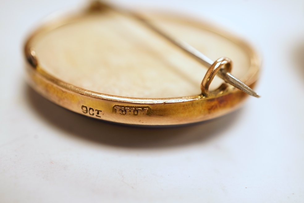 A Satsuma brooch, set with a circular Satsuma plaque depicting an oiran with gilded hair ornaments, mounted in 9ct gold, 3.3cm diameter, British hallmarks; together with an oval shell cameo brooch depicting a classical w